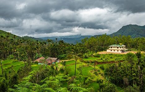House,At,Remote,Village,Isolated,With,Mountain,Coverd,Clouds,And